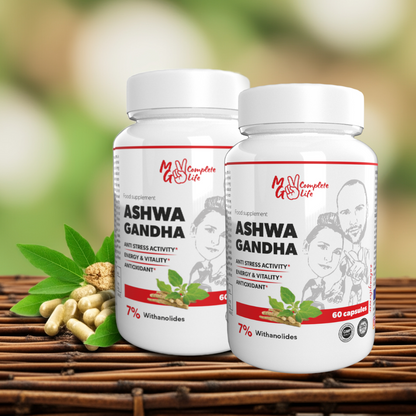 Two bottles of Ashwa Gandha supplement on a wooden surface with green leaves and capsules.
